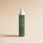 Firm+ Collagen Night Cream in green airless pump bottle against beige background